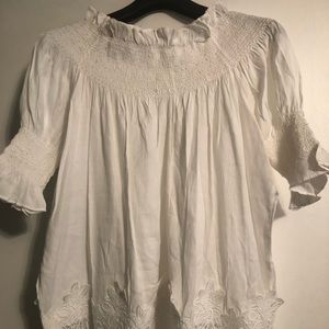 A white off shoulder tunic.